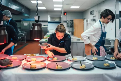 Plusieurs jeunes en train de préparer les plats en formation cuisine 